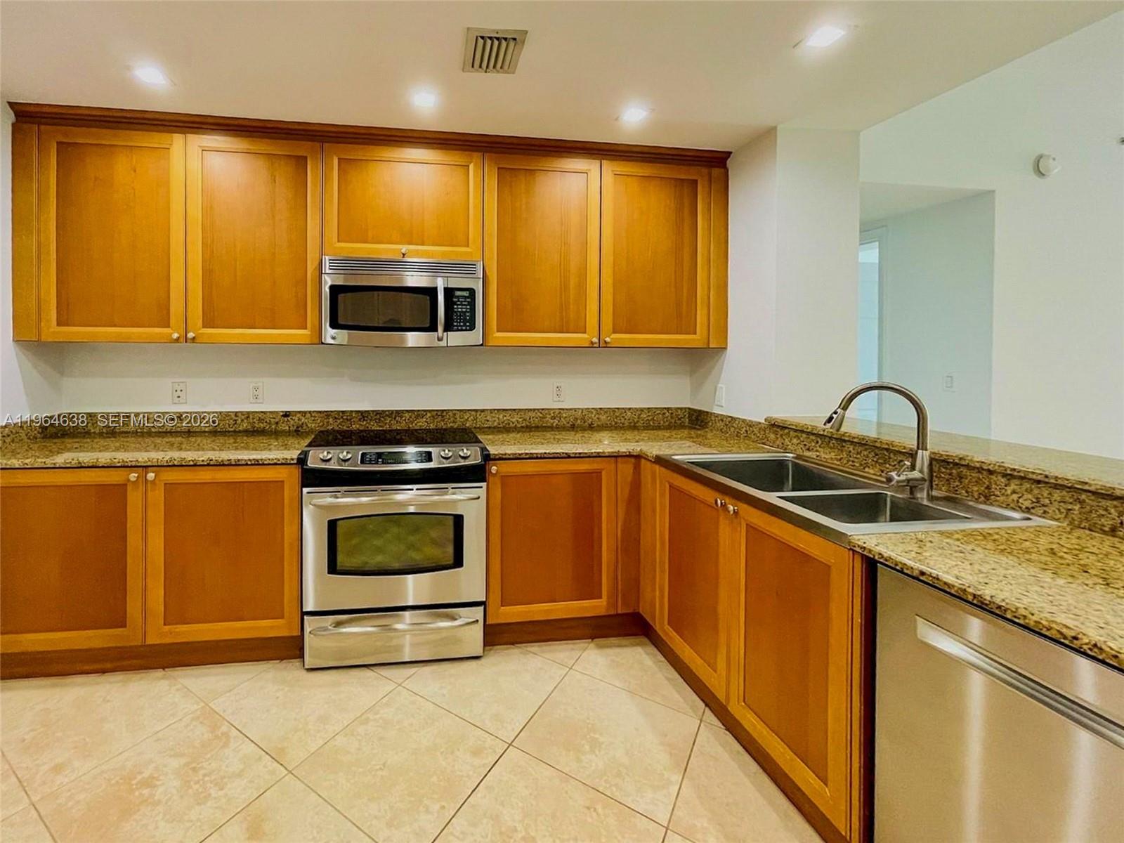 55 Merrick Way, Unit 715 Coral Gables, FL 33134 - Photo 26 of 52 a kitchen with granite countertop a sink and stainless steel appliances