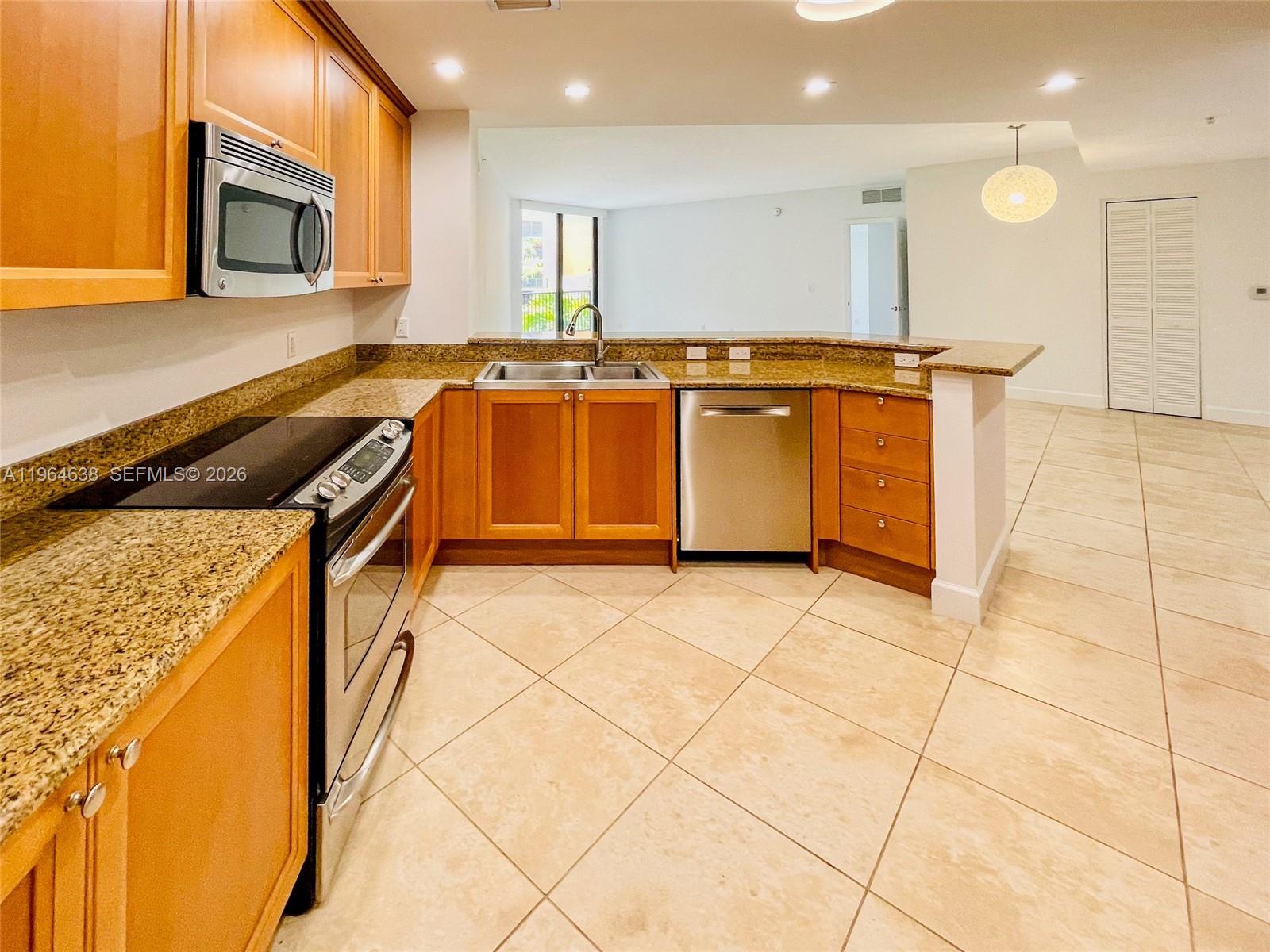 55 Merrick Way, Unit 715 Coral Gables, FL 33134 - Photo 30 of 52 a kitchen with stainless steel appliances granite countertop a sink and a stove
