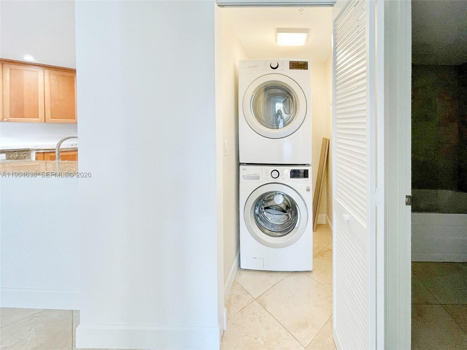 55 Merrick Way, Unit 715 Coral Gables, FL 33134 - Photo 33 of 52 a utility room with dryer and washer