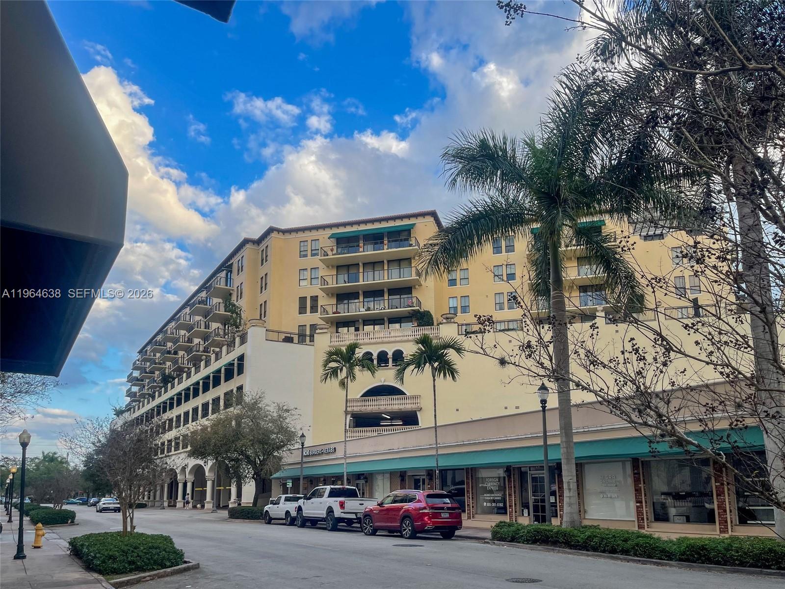 55 Merrick Way, Unit 715 Coral Gables, FL 33134 - Photo 36 of 52 a front view of building with cars parked