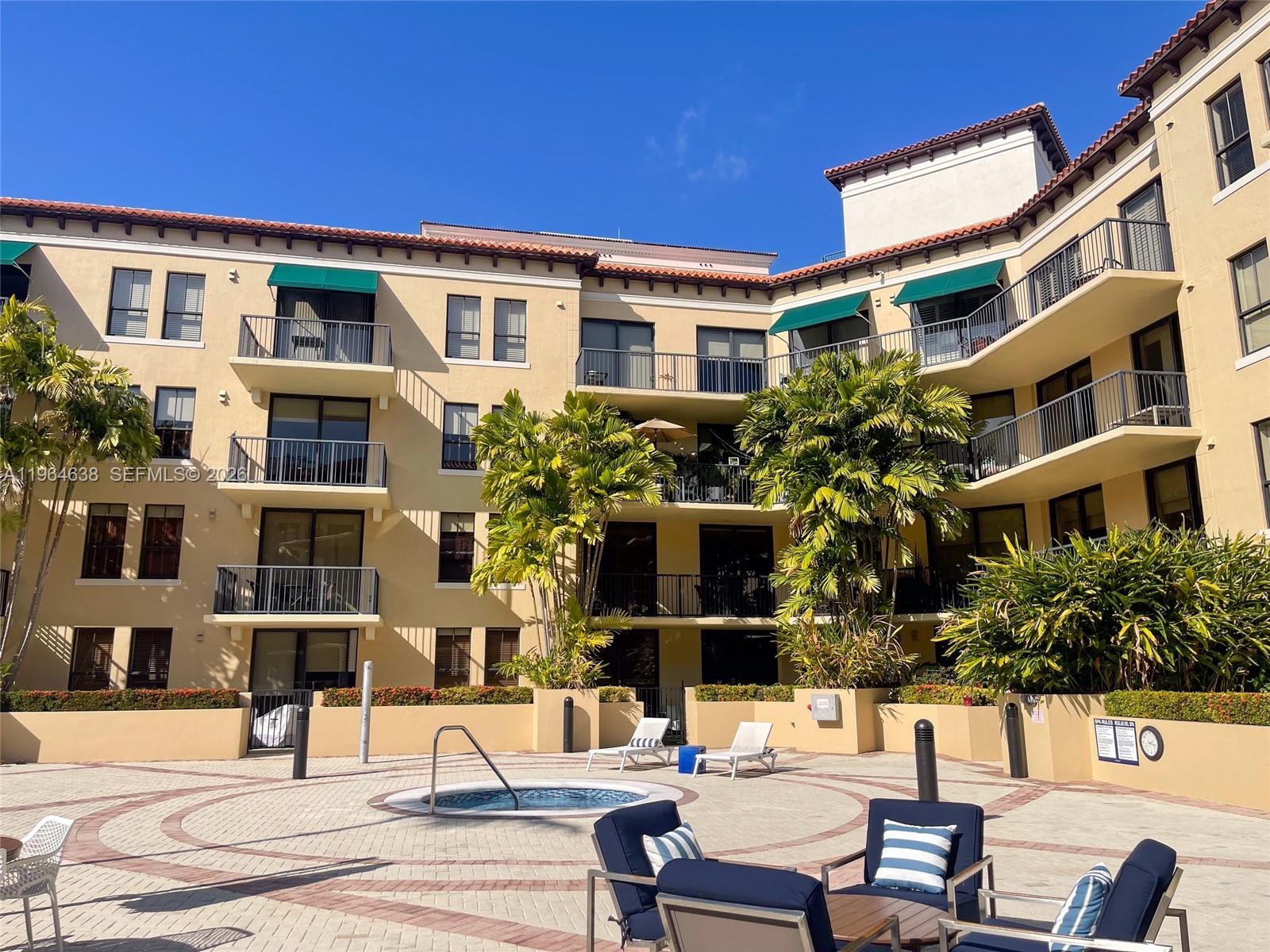55 Merrick Way, Unit 715 Coral Gables, FL 33134 - Photo 40 of 52 a view of a building with a yard