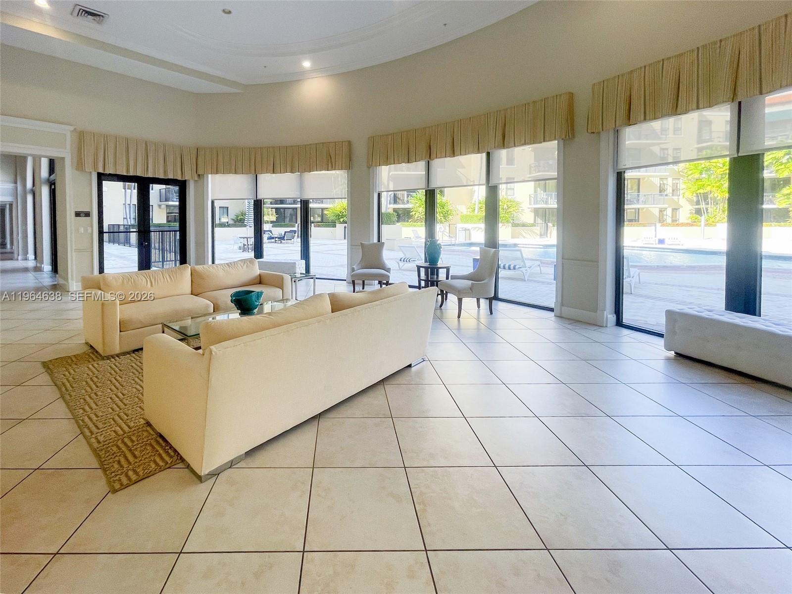 55 Merrick Way, Unit 715 Coral Gables, FL 33134 - Photo 45 of 52 a living room with a large window