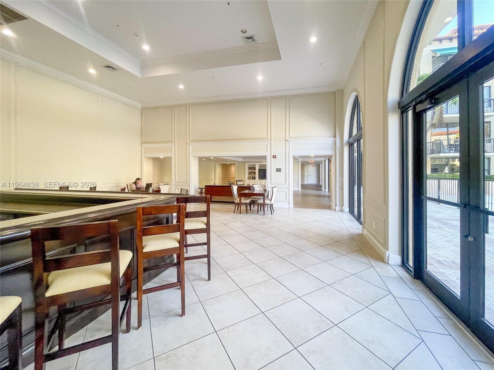 55 Merrick Way, Unit 715 Coral Gables, FL 33134 - Photo 46 of 52 a lobby with furniture and a floor to ceiling window