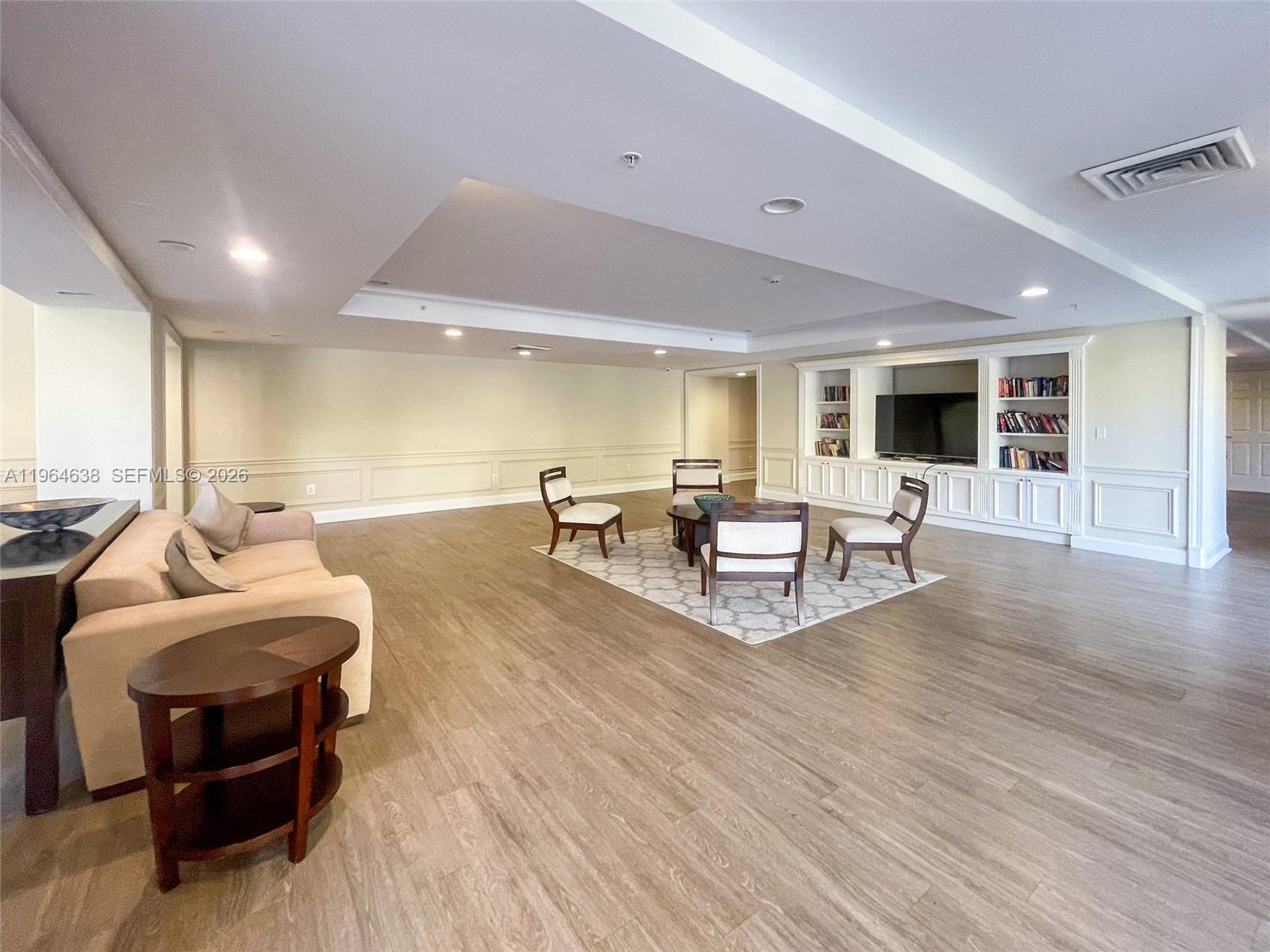 55 Merrick Way, Unit 715 Coral Gables, FL 33134 - Photo 47 of 52 a living room with furniture and a wooden floor