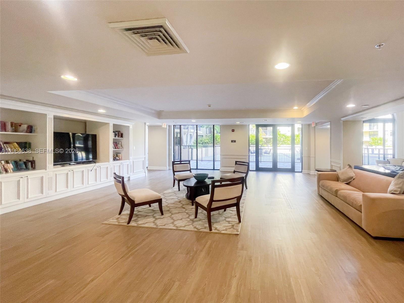 55 Merrick Way, Unit 715 Coral Gables, FL 33134 - Photo 48 of 52 a living room with furniture and a wooden floor