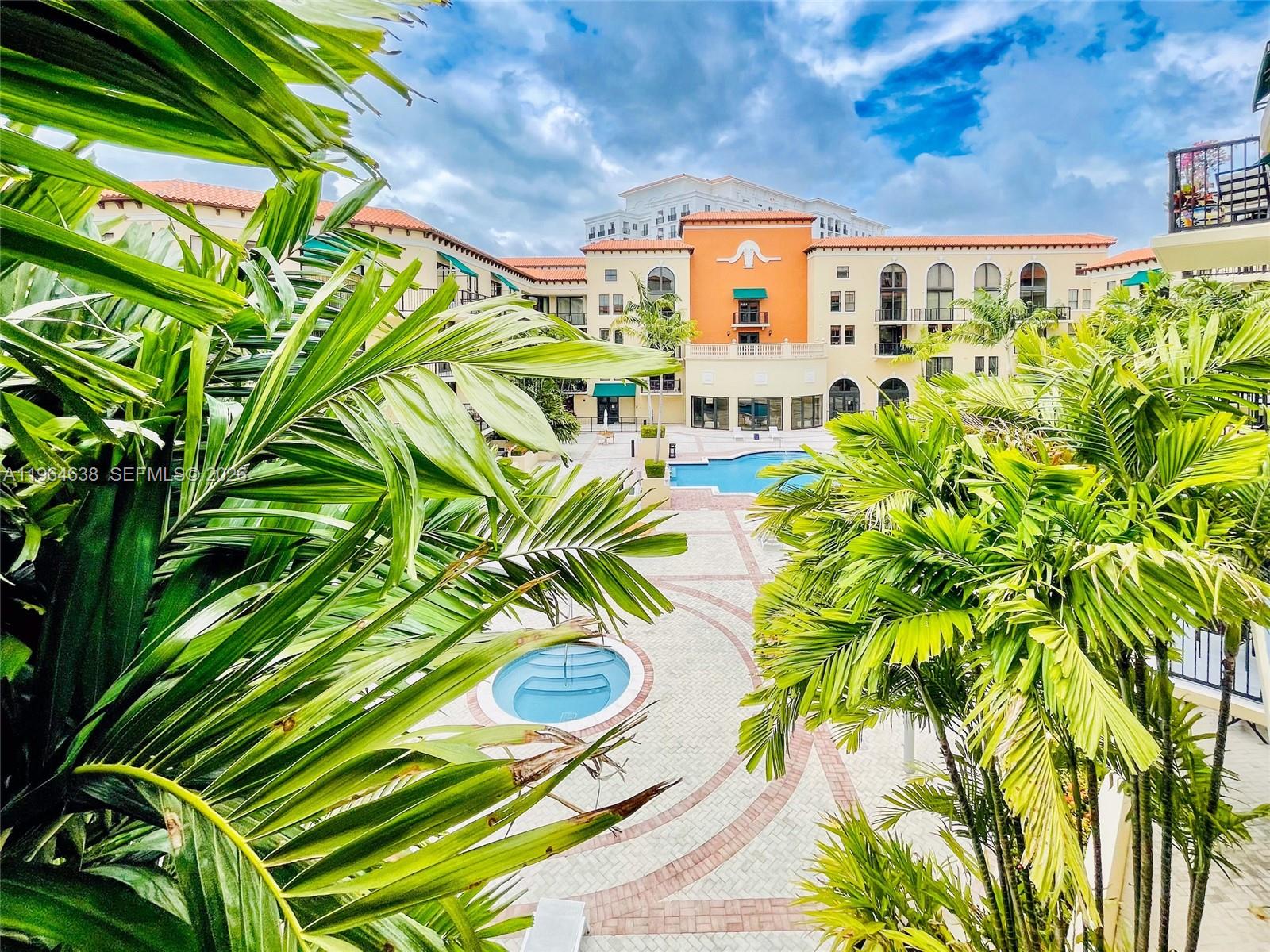 55 Merrick Way, Unit 715 Coral Gables, FL 33134 - Photo 7 of 52 a view of a swimming pool with a garden