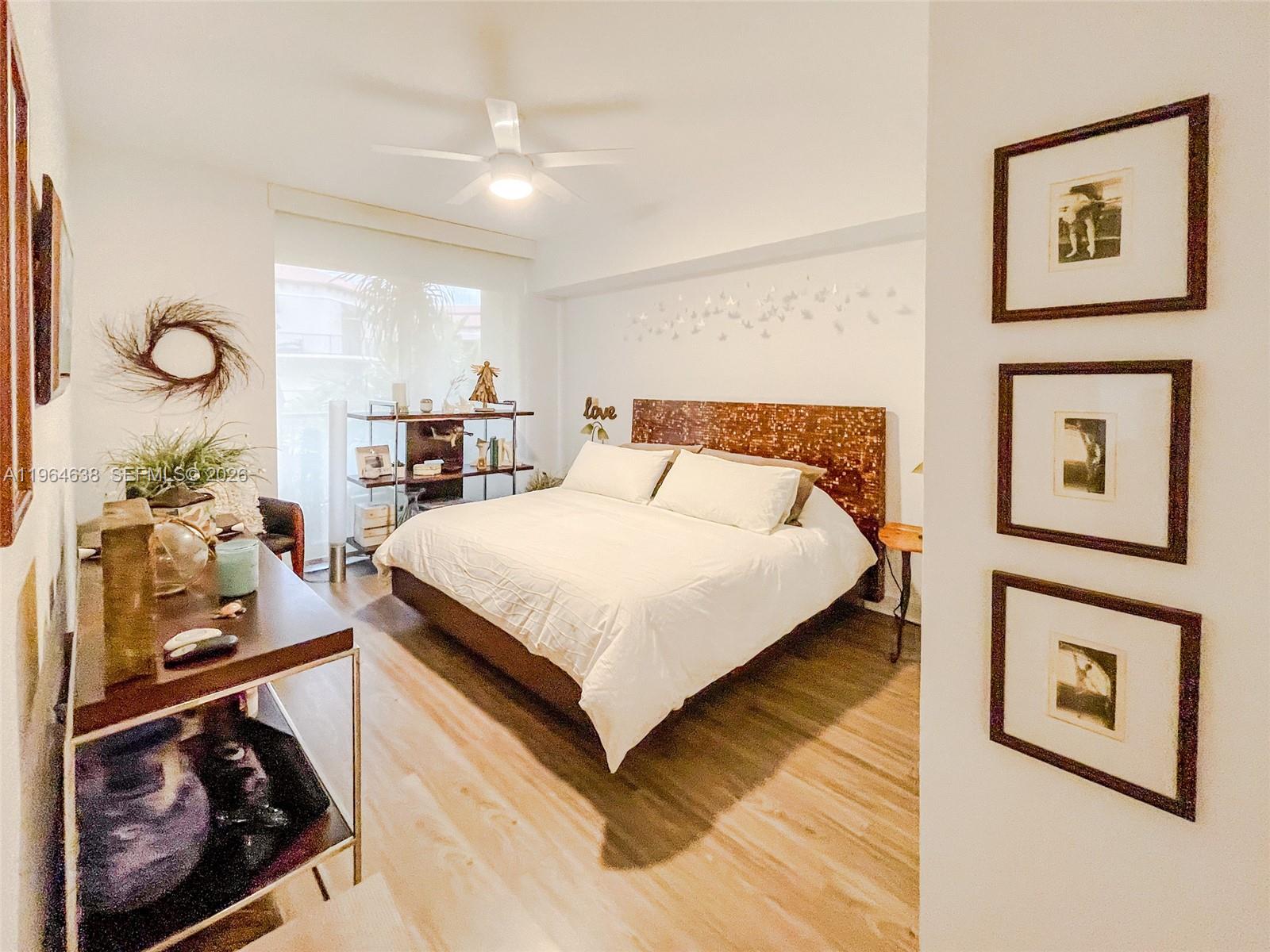 55 Merrick Way, Unit 715 Coral Gables, FL 33134 - Photo 10 of 52 a bedroom with a bed and dresser with mirror