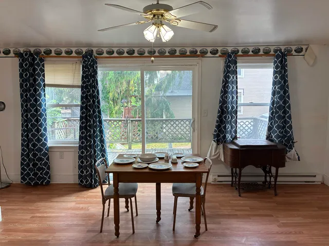 a dining room with furniture and window