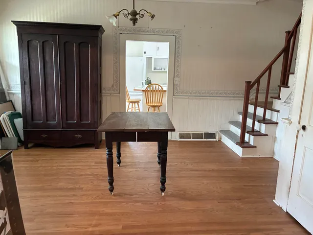 a view of a hallway with wooden floor and windows