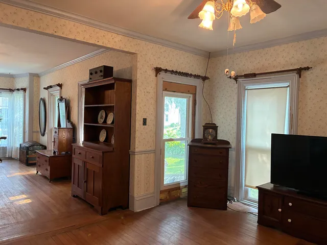 a living room with furniture rug and wooden floor
