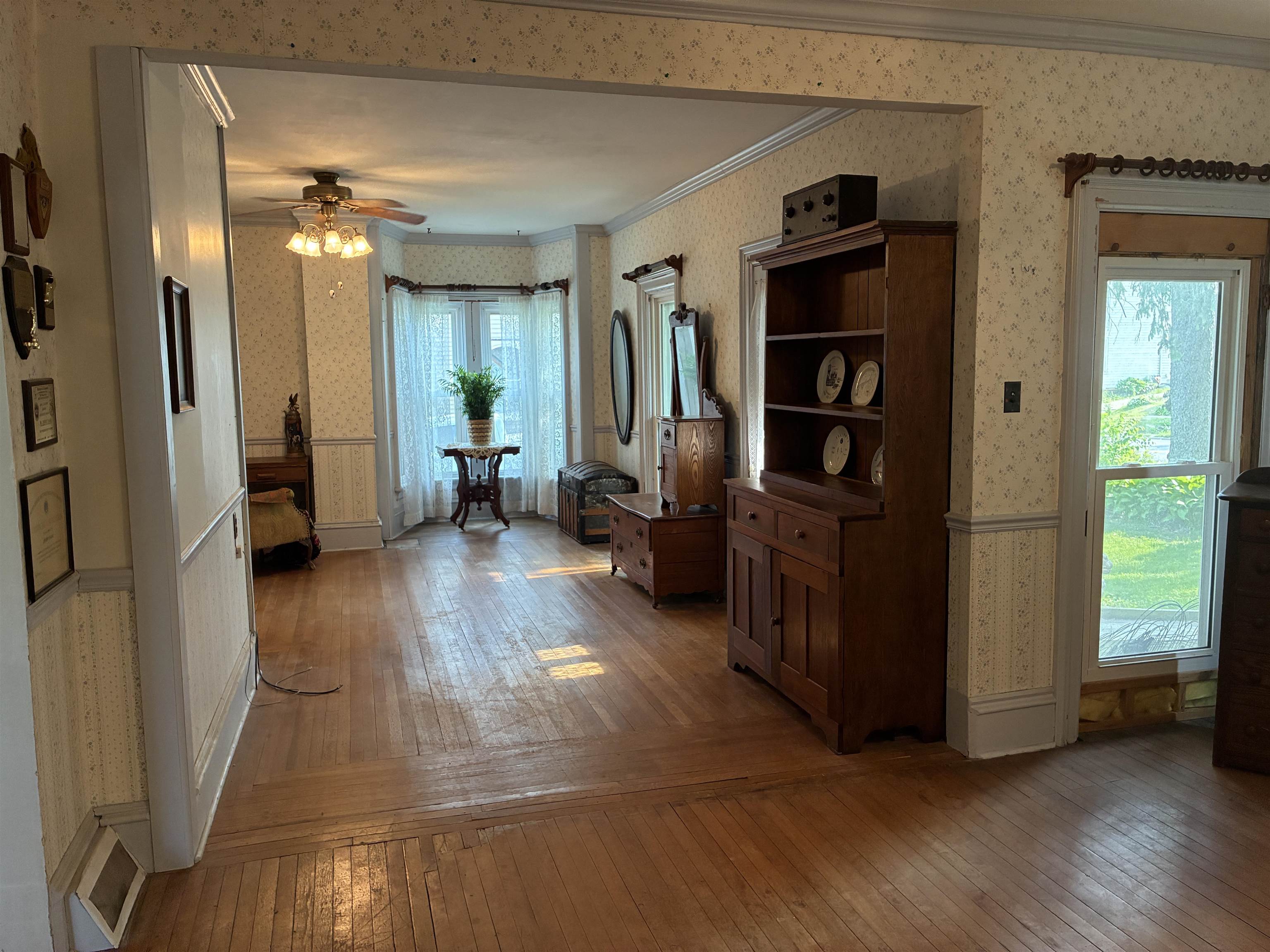115 North Clay Street Mount Carroll, IL 61053 - Photo 17 of 61 a view of a hallway with wooden floor and windows