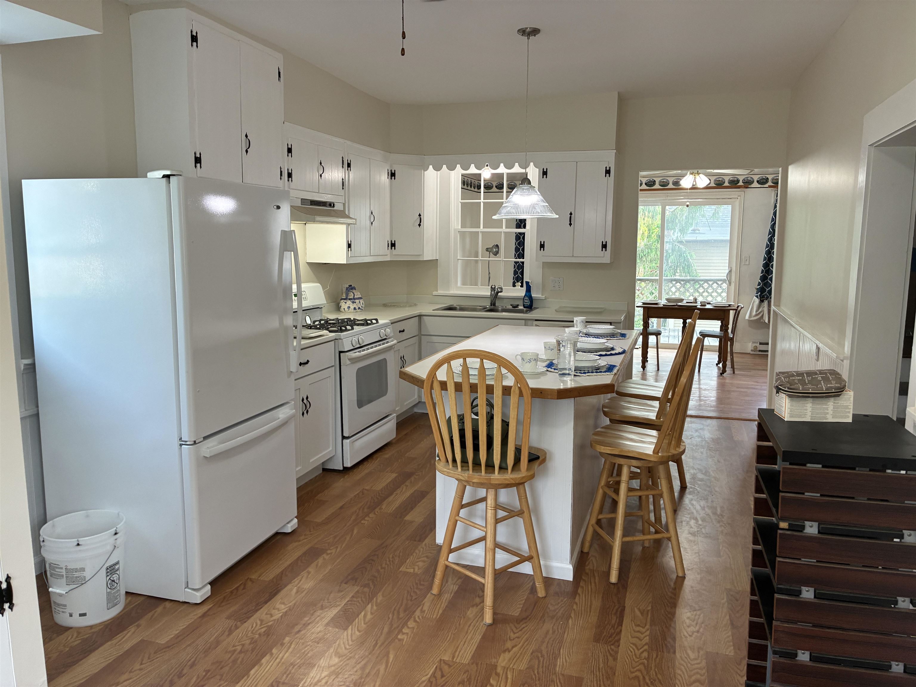 115 North Clay Street Mount Carroll, IL 61053 - Photo 2 of 61 a kitchen with stainless steel appliances granite countertop a refrigerator a stove a sink a dining table and chairs with wooden floor