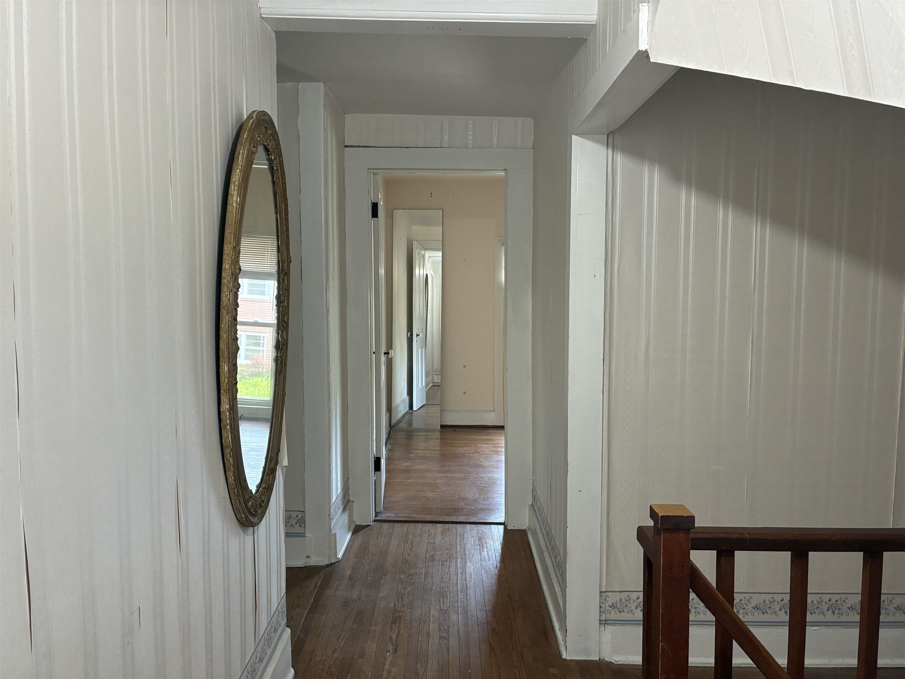 115 North Clay Street Mount Carroll, IL 61053 - Photo 27 of 61 a view of a hallway with wooden floor and door