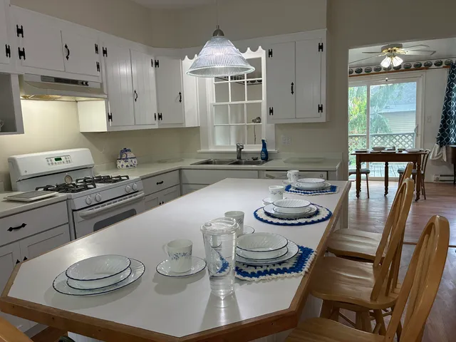 a kitchen with a sink a stove and cabinets