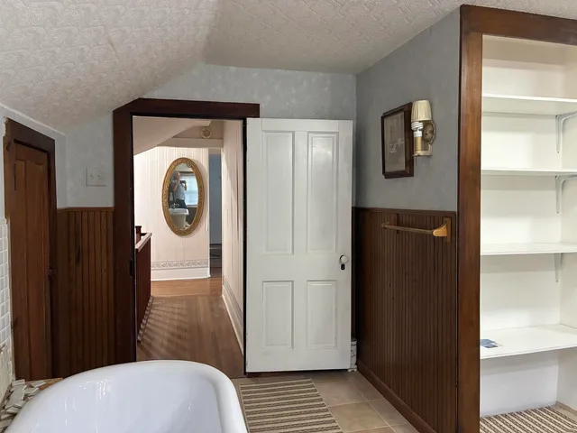 a room with a bed and a chandelier