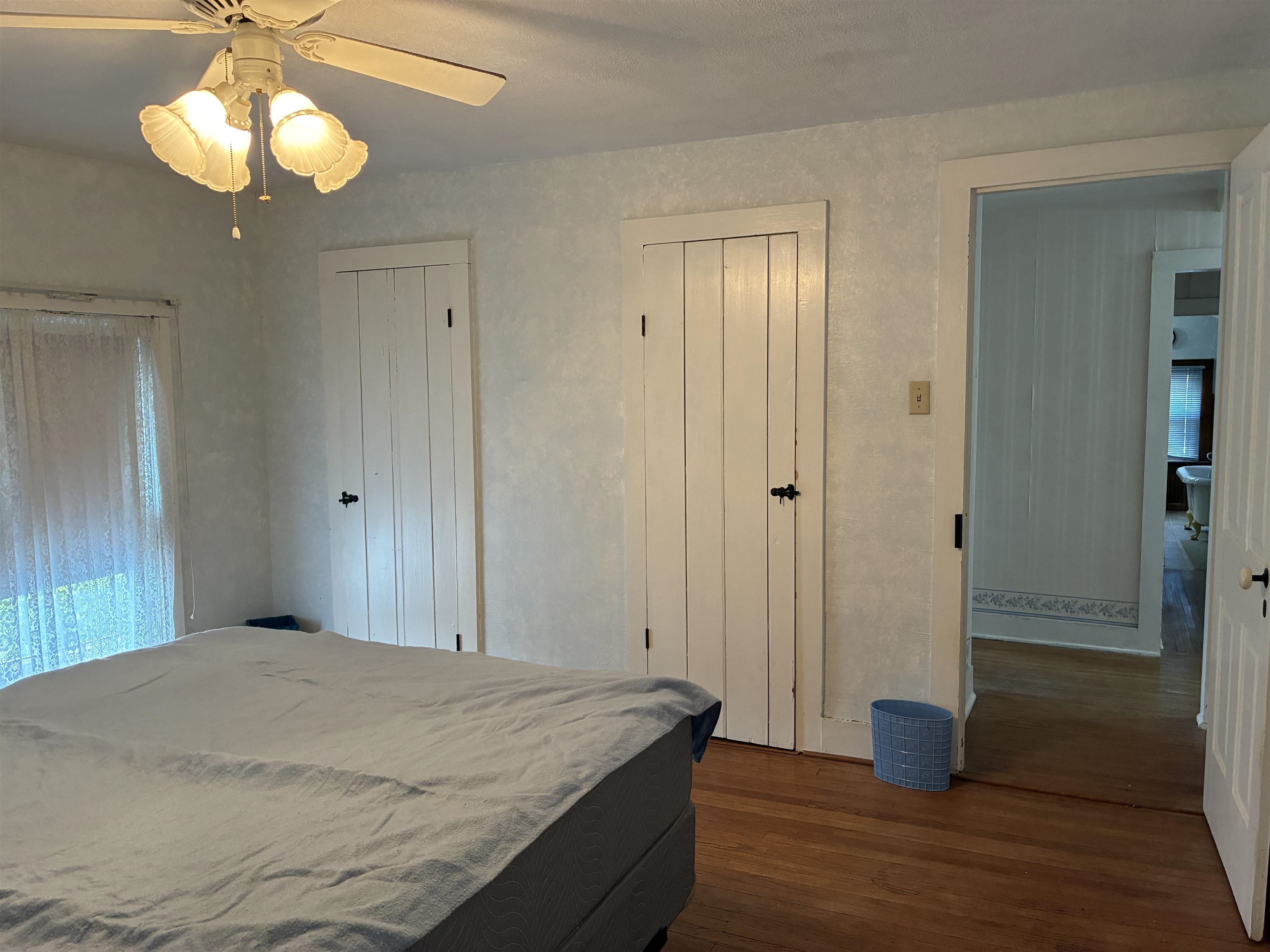 115 North Clay Street Mount Carroll, IL 61053 - Photo 34 of 61 a bedroom with wooden floor and chandelier