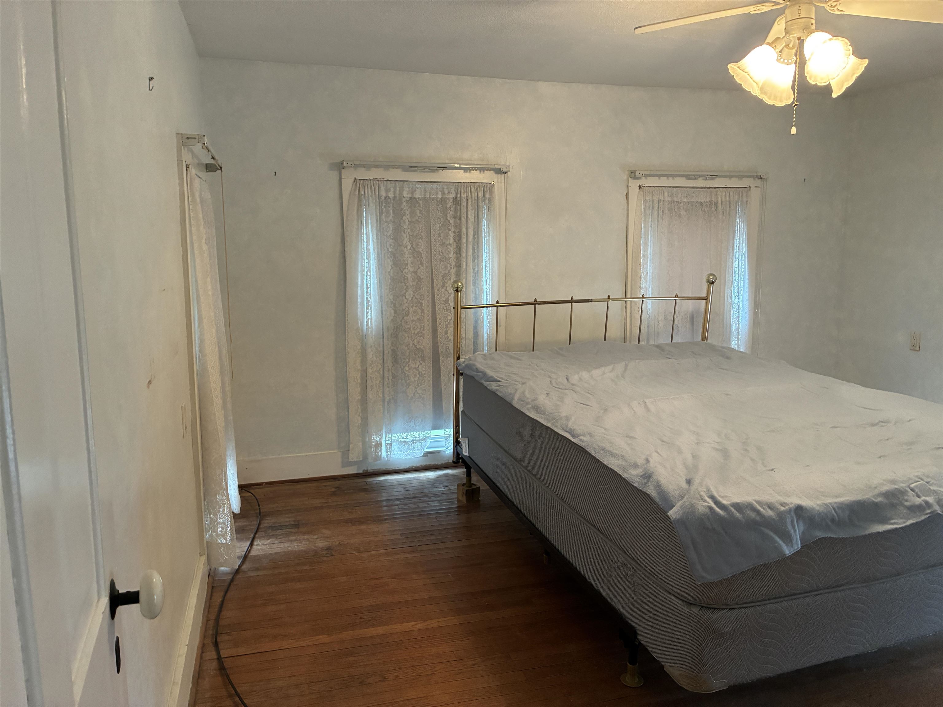 115 North Clay Street Mount Carroll, IL 61053 - Photo 35 of 61 a room with a bed and a chandelier