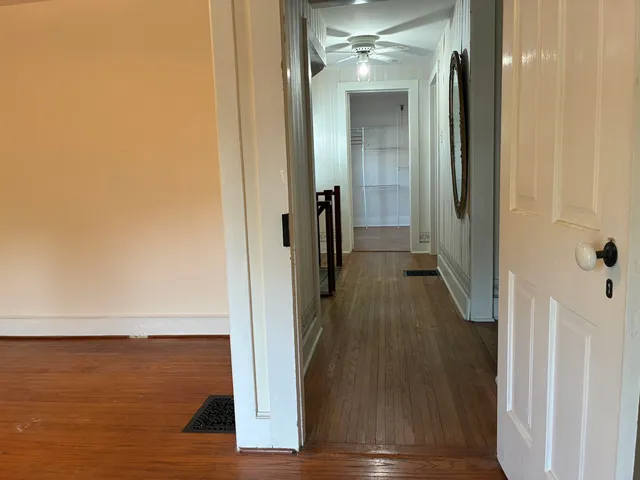 a view of an empty room and wooden floor