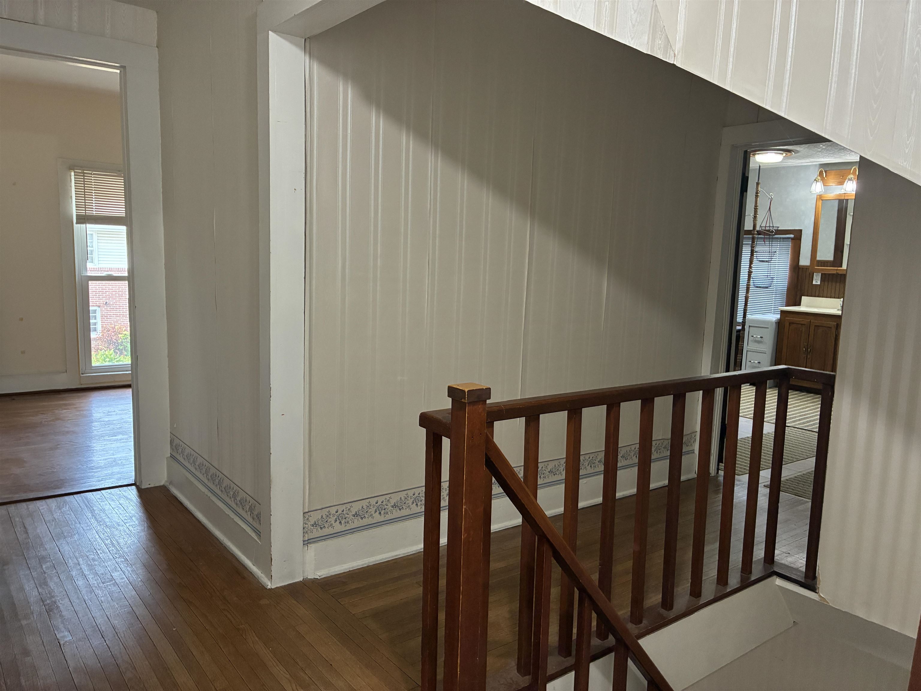115 North Clay Street Mount Carroll, IL 61053 - Photo 41 of 61 a view of a hallway with wooden floor and stairs
