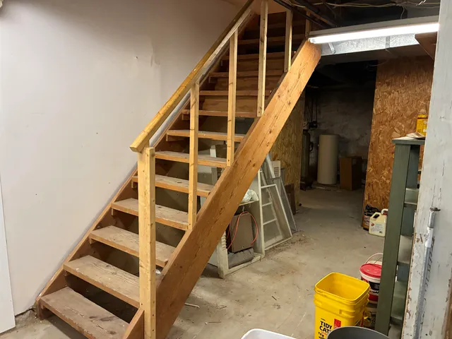 a view of a white house with large windows and a table