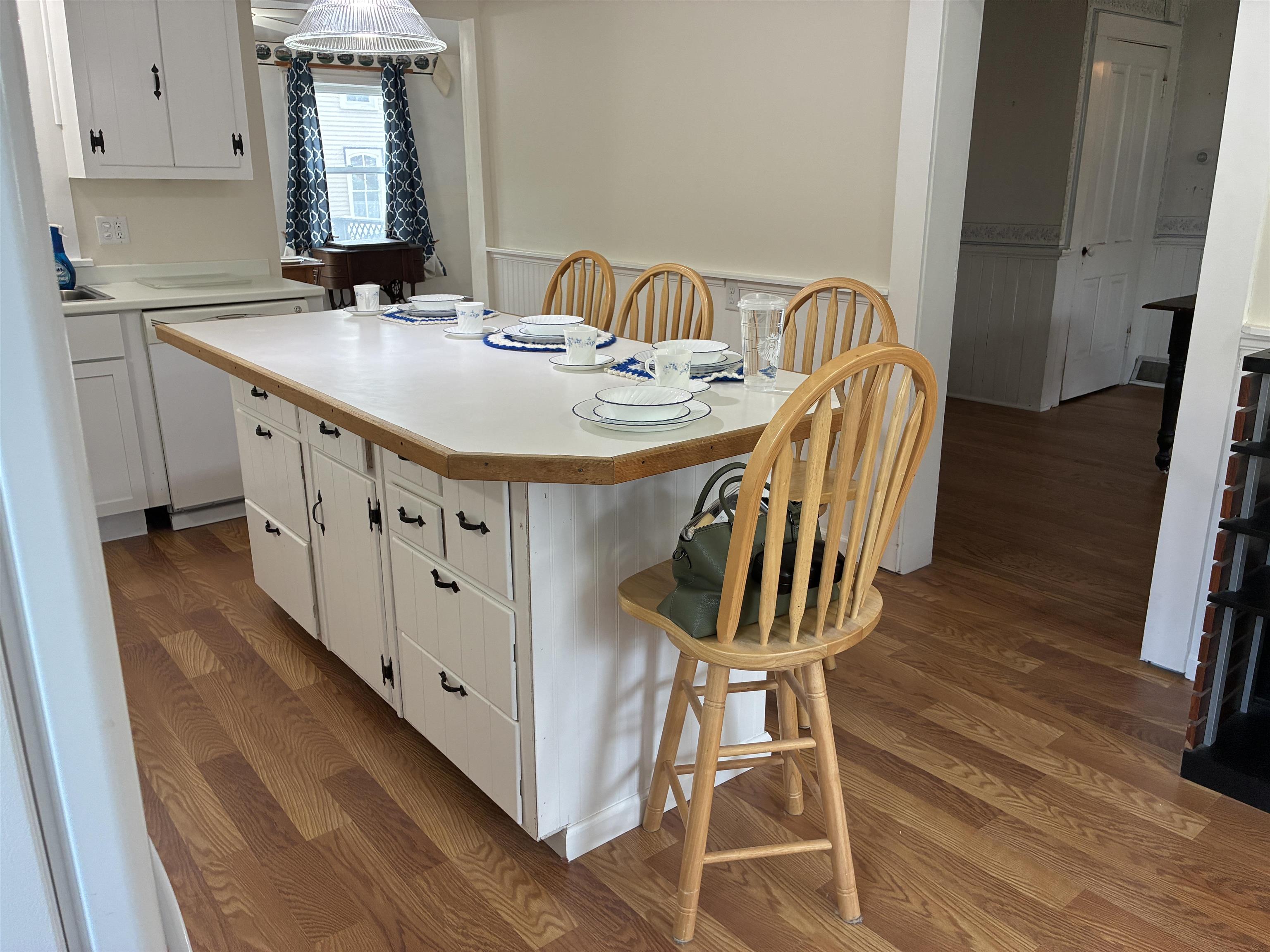 115 North Clay Street Mount Carroll, IL 61053 - Photo 6 of 61 a kitchen with stainless steel appliances granite countertop a sink a stove a refrigerator a washer and dryer with wooden floor