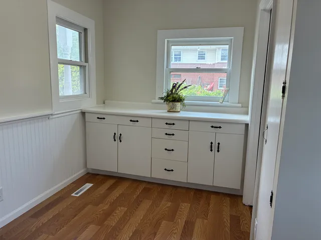 a view of a dining room with furniture window and wooden floor