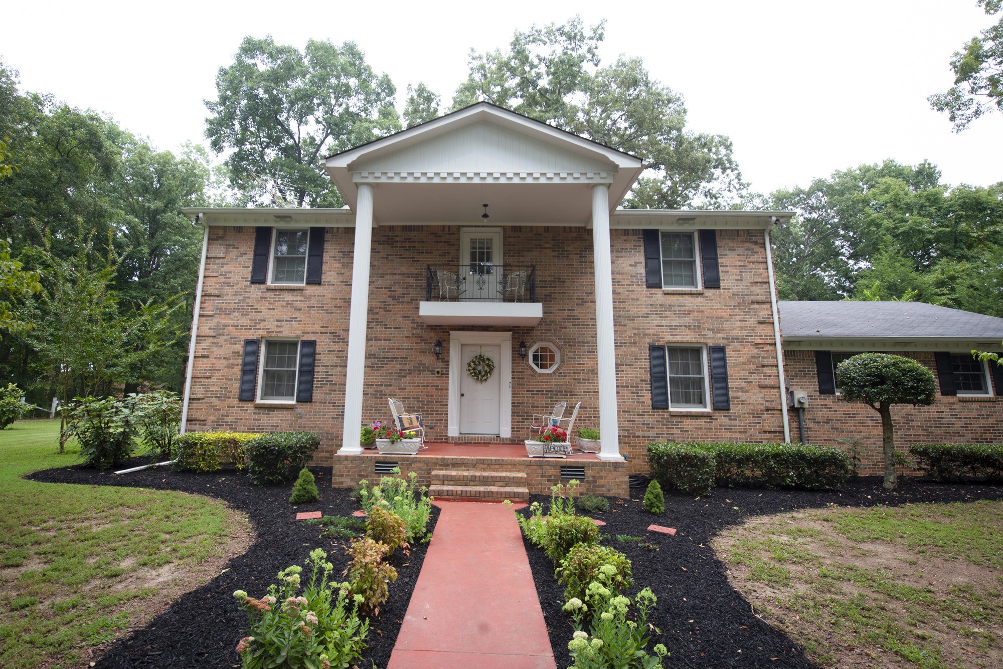 a front view of a house with garden