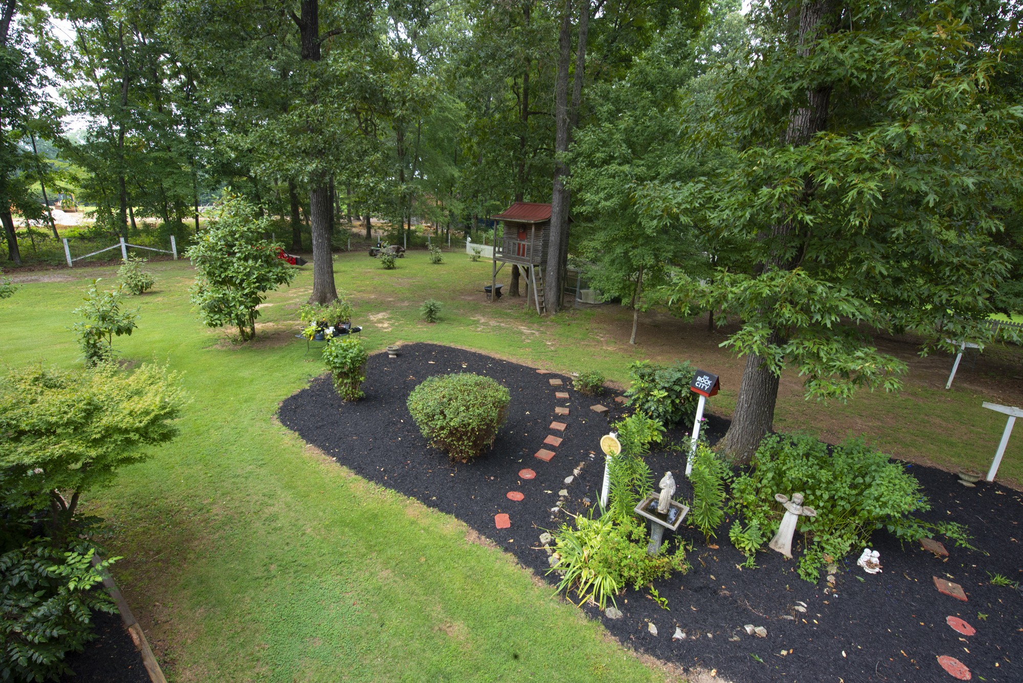 836 Dripping Springs Road Winchester, TN 37398 - Photo 31 of 37 a view of a garden with lawn chairs and a large tree