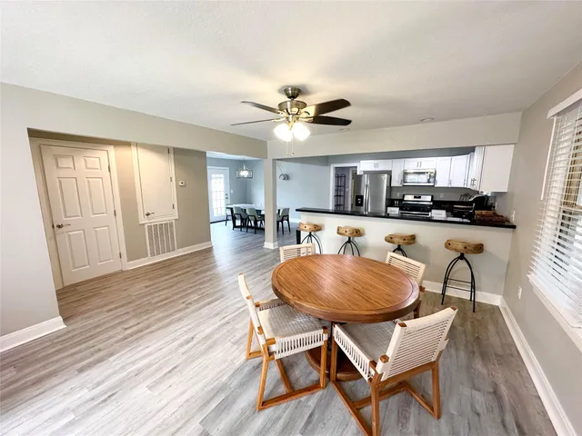 a view of a dining room with furniture and wooden floor