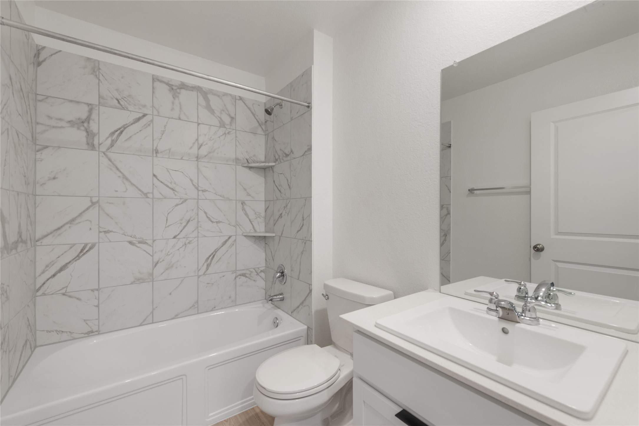 153 Sormonne Loop Kyle, TX 78640 - Photo 13 of 17 a bathroom with a bathtub shower sink vanity mirror and toilet