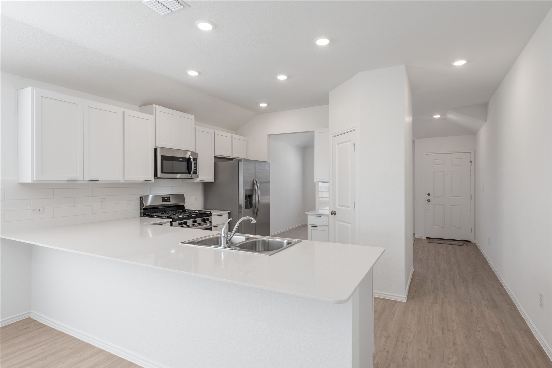 153 Sormonne Loop Kyle, TX 78640 - Photo 2 of 17 a kitchen with stainless steel appliances a sink stove and refrigerator