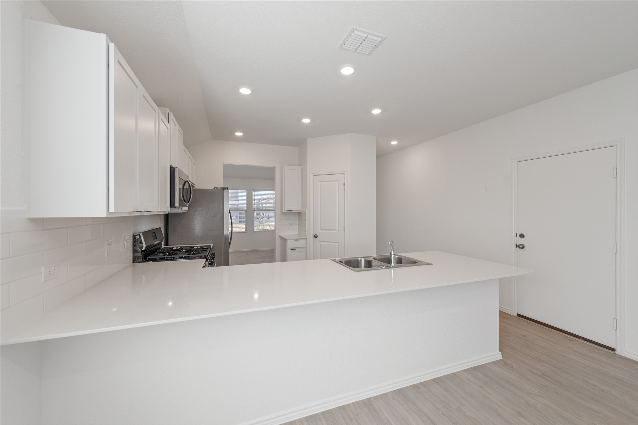 153 Sormonne Loop Kyle, TX 78640 - Photo 7 of 17 a kitchen with a sink stainless steel appliances and cabinets