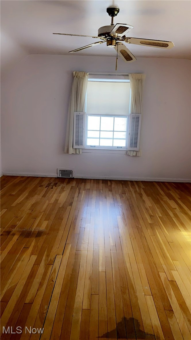 15657 Fenemore Road Cleveland, OH 44112 - Photo 11 of 26 Unfurnished room featuring ceiling fan, wood-type flooring, and lofted ceiling