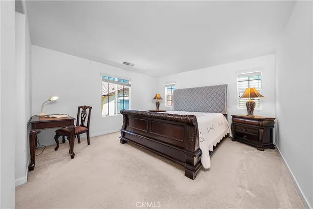 a bedroom with a bed and a desk