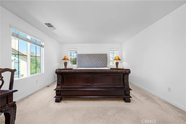 a bed sitting in a room next to a window