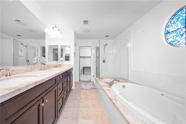 a spacious bathroom with a granite countertop tub sink and mirror