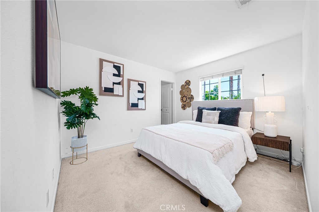 907 North Cornejo Way Azusa, CA 91702 - Photo 16 of 22 a bedroom with a large bed and a potted plant