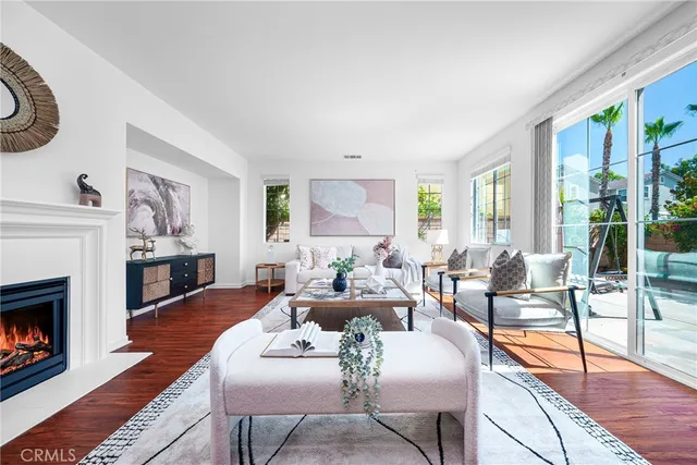 a living room with furniture large window and a fireplace