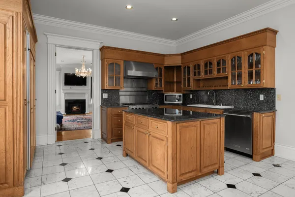 a view of a room with furniture a chandelier and wooden floor