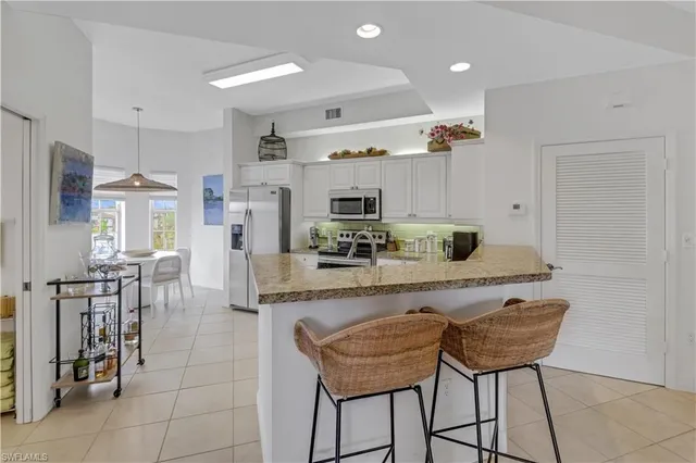 a large kitchen with a table and chairs