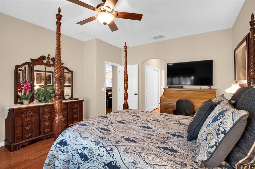 16411 Southwest 14th Avenue Road Ocala, FL 34473 - Photo 13 of 59 a bedroom with a bed and a flat screen tv