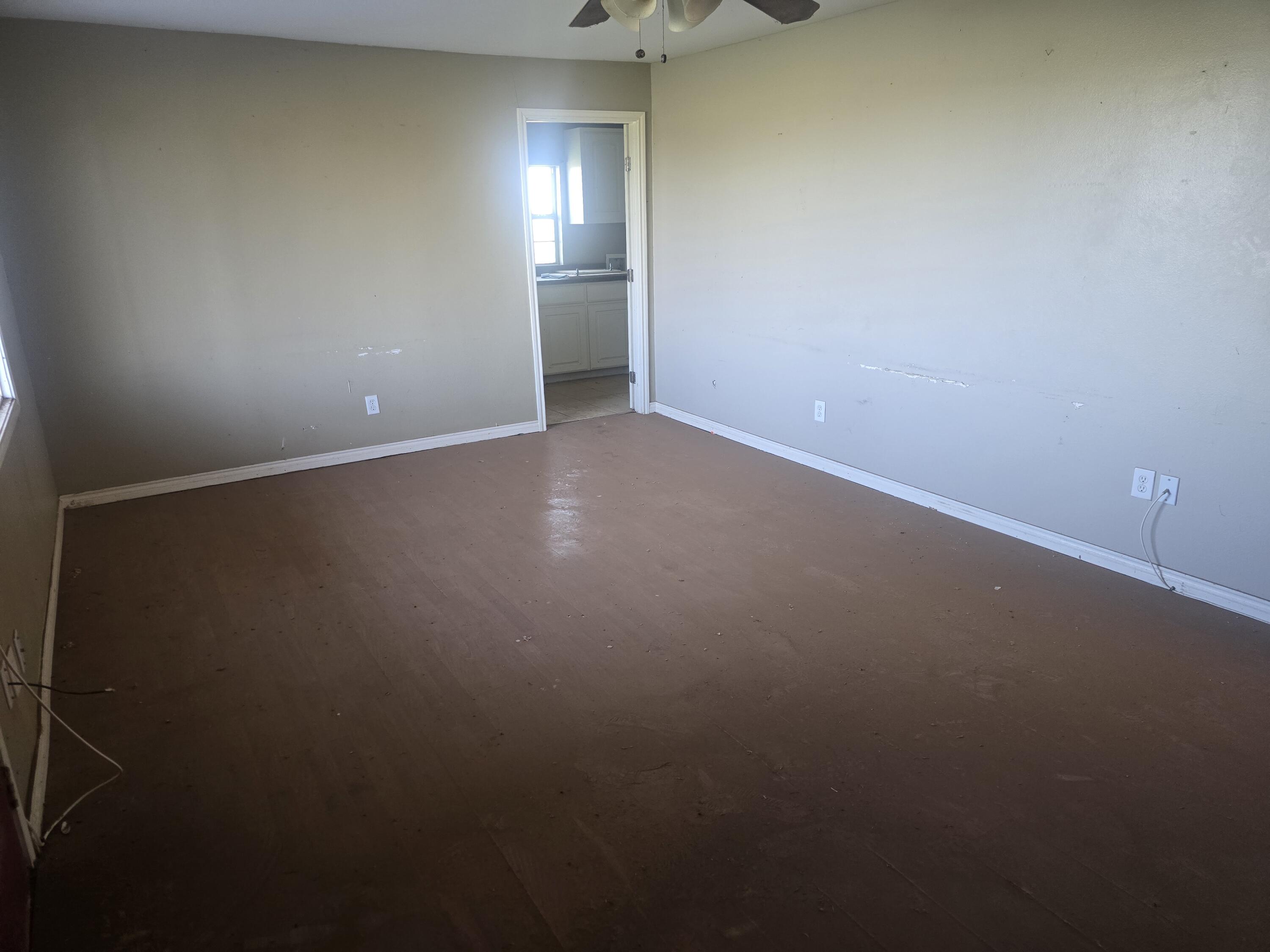 1611 County Road 50 Plainview, TX 79072 - Photo 2 of 11 an empty room with windows
