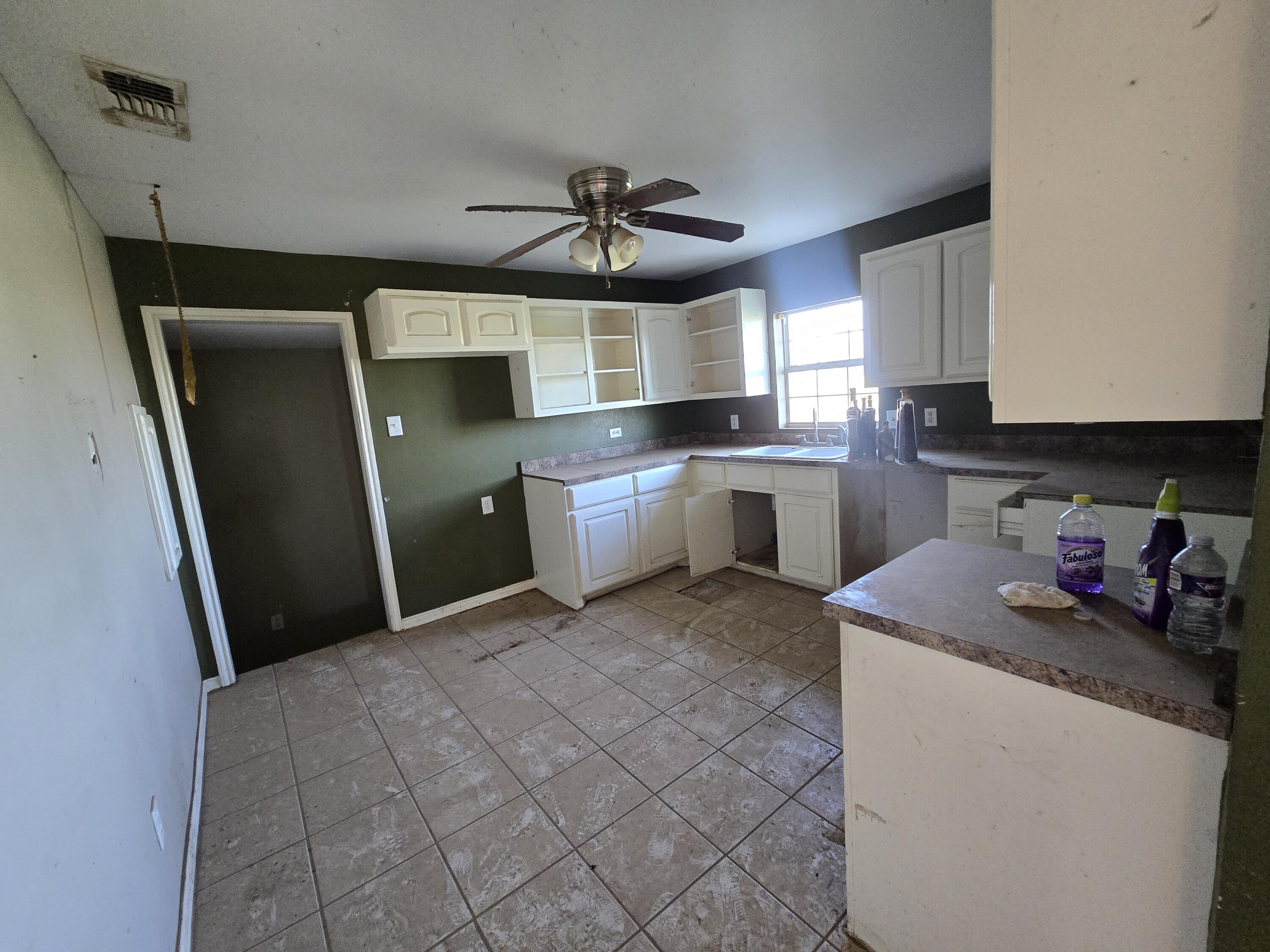 1611 County Road 50 Plainview, TX 79072 - Photo 3 of 11 a kitchen with stainless steel appliances granite countertop a sink stove and refrigerator