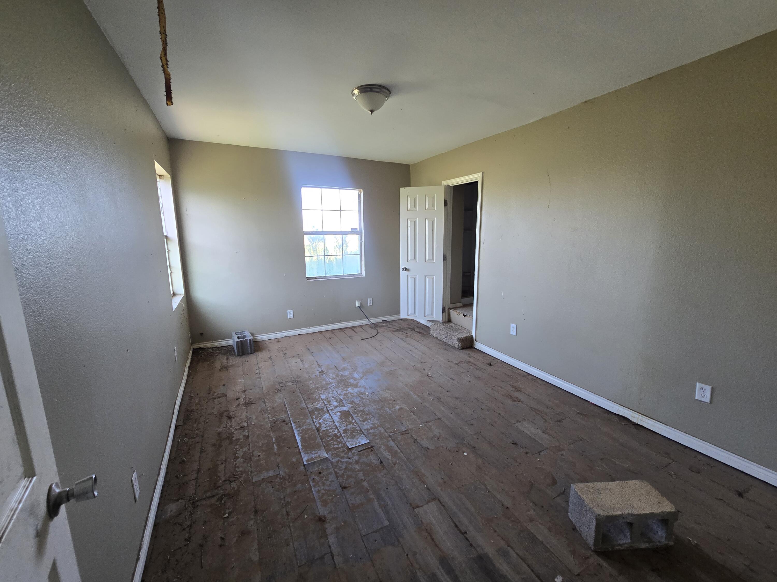 1611 County Road 50 Plainview, TX 79072 - Photo 6 of 11 an empty room with windows