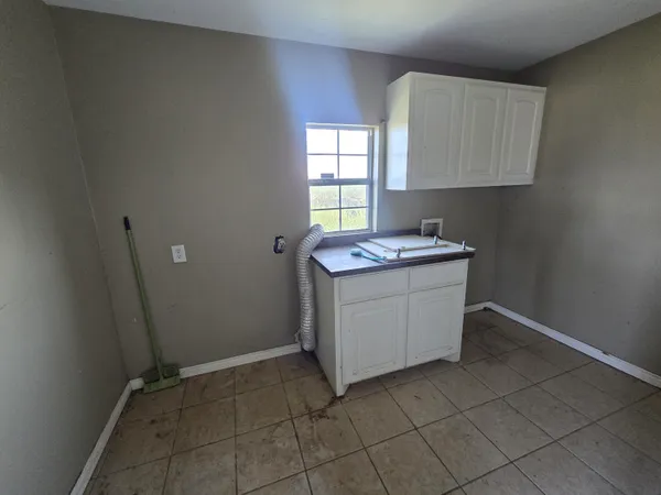 a utility room with cabinets washer and dryer