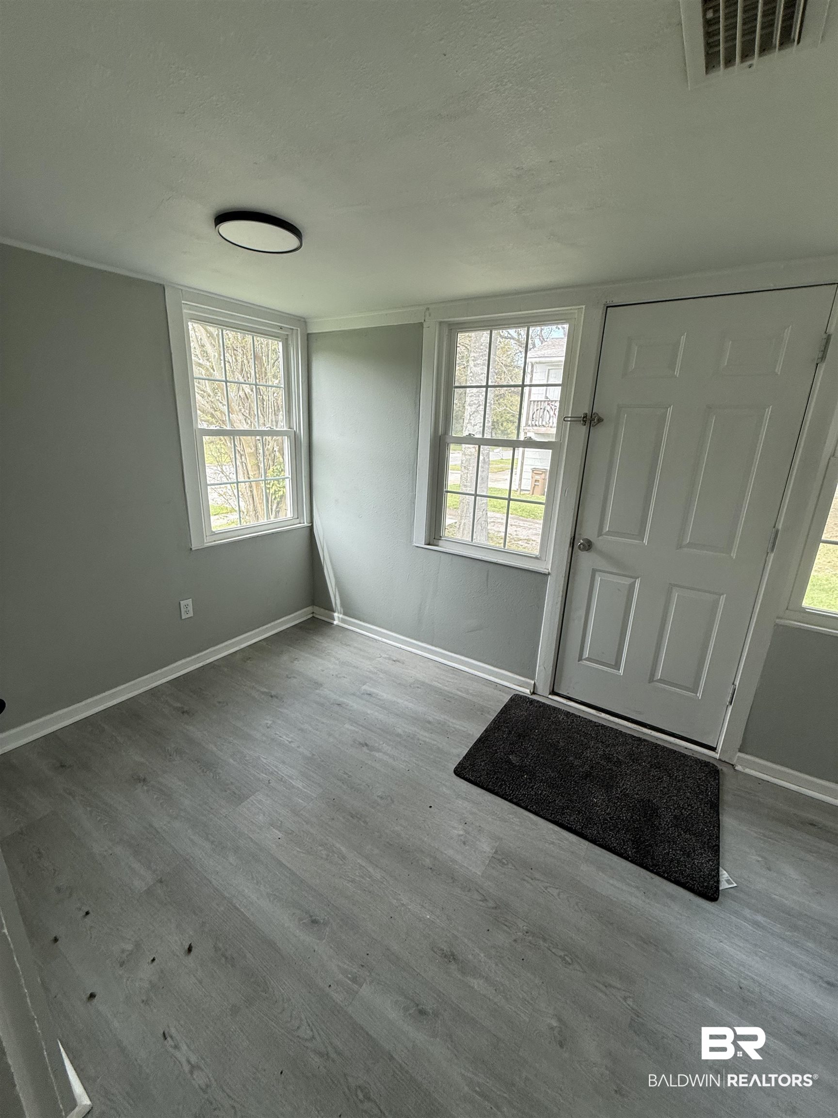 1848 Canal Street Mobile, AL 36606 - Photo 8 of 11 Foyer entrance with plenty of natural light, light wood-style floors, and a textured ceiling