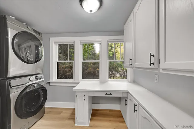 a view of a kitchen with sink washer and dryer