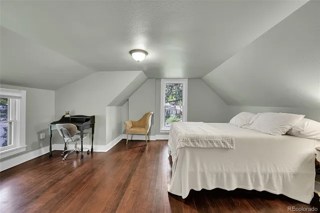 a bedroom with a bed and a chair