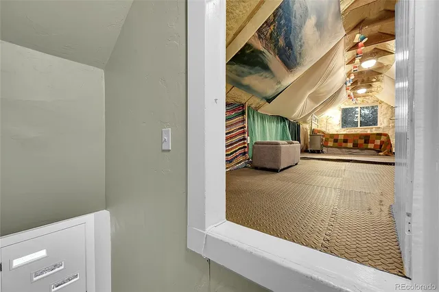 a hallway with a couch and chandelier