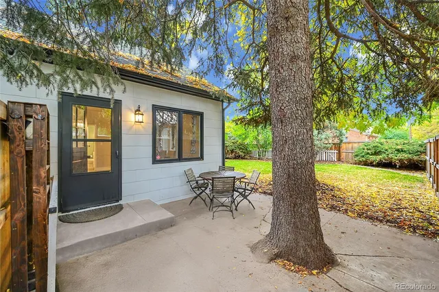 a view of a house with backyard porch and sitting area
